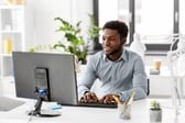 A team member uses their computer at home