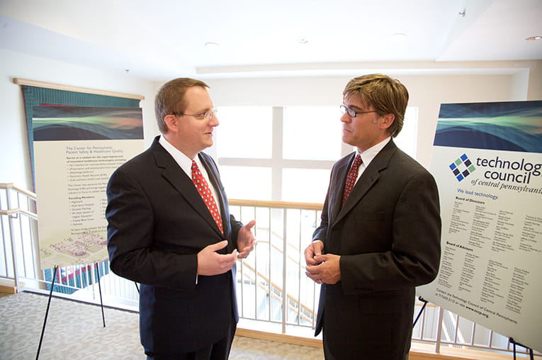 Doug and another business person having discussions outside a meeting