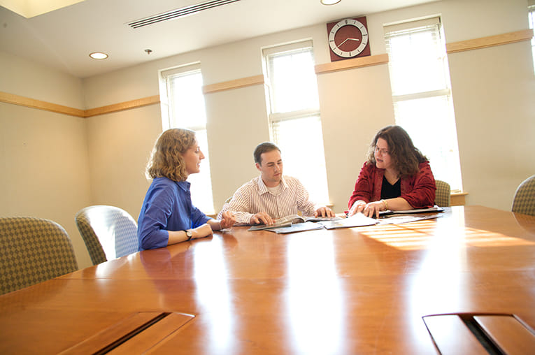 The growth team working on market strategy at a large table