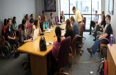 A team prepares for a meeting in a room full of tables