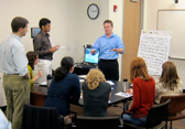 A man in a blue shirt addresses the company's competitive intelligence strategy