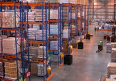 A warehouse backshop photo from high up showing rows of full shelving