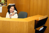 A business office worker smiles from her desk