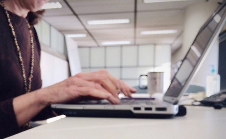 a sales person at a laptop A close-up shot of a persons hands on a laptop keyboard