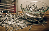 A glass bowl sits on a counter which appears half full, with the other half of its contents scattered across the counter