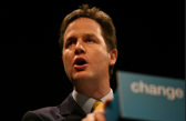 A tight headshot of a leader speaking with a sign in the background that says change