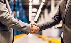 Two business professionals shake hands